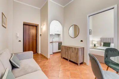 a living room with a couch and a bedroom at URBANA 18 in Rome
