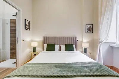 a bedroom with a large bed and two lamps at URBANA 18 in Rome