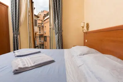 a bedroom with a bed with two towels on it at Allegria Fitzroy Cesar in Rome