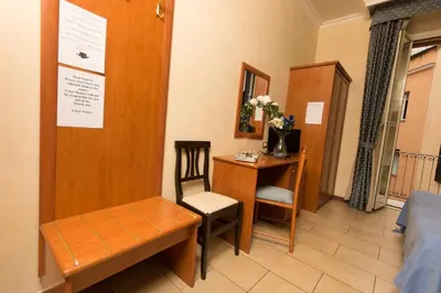 a room with a bed and a table and a desk at Allegria Fitzroy Cesar in Rome