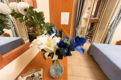 a vase filled with blue and white flowers on a table at Allegria Fitzroy Cesar in Rome