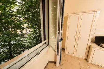 a window in a room with a view of a tree at Allegria Fitzroy Cesar in Rome