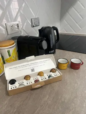 a box of donuts sitting on a counter next to a coffee maker at Casa Riboty by GHOR in Rome