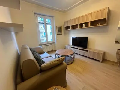 a living room with a couch and a tv at Casa Riboty by GHOR in Rome
