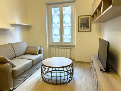 a living room with a couch and a table at Casa Riboty by GHOR in Rome