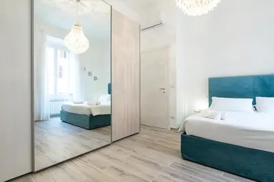 a large mirror in a bedroom with a bed at Trastevere Exclusive Three Bedroom Apartment in Rome