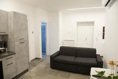 a living room with a couch and a kitchen at A Casa di Lù a Roma Casa Vacanze in Rome