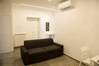 a living room with a brown couch and a table at A Casa di Lù a Roma Casa Vacanze in Rome