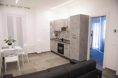 a living room with a couch and a kitchen at A Casa di Lù a Roma Casa Vacanze in Rome