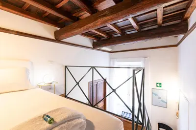 a bedroom with a bed and a window at Spanish Steps Exclusive Apartment in Rome