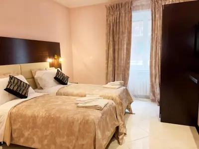 two beds in a hotel room with towels on them at Sofia Guest House in Rome