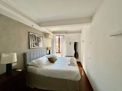a bedroom with a bed with a blue headboard at Serpenti 147 - Colosseum Apt in Rome