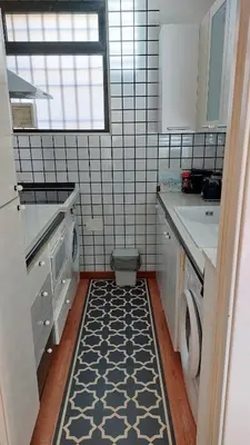 a small kitchen with a washer and dryer in it at Serpenti 147 - Colosseum Apt in Rome