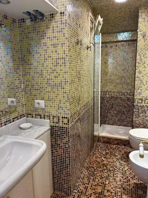 a bathroom with a tub and a sink and a shower at Serpenti 147 - Colosseum Apt in Rome