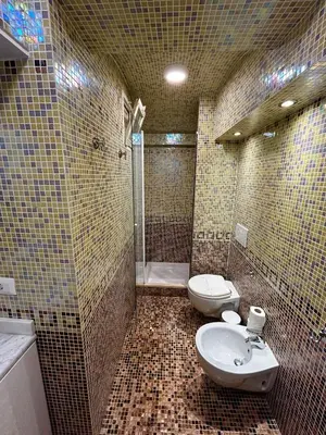 a bathroom with a toilet and a sink and a shower at Serpenti 147 - Colosseum Apt in Rome