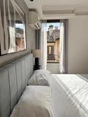 a bedroom with a large bed with a window at Serpenti 147 - Colosseum Apt in Rome
