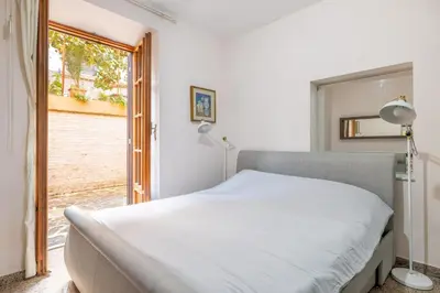 a bedroom with a bed and a window at Maximo Luxe -Villa & Apartment in Rome