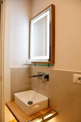 a bathroom with a sink and a mirror at Domus Maxima - Rome Suite & Rooms in Rome
