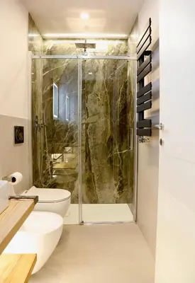 a bathroom with a toilet and a glass shower at Domus Maxima - Rome Suite & Rooms in Rome