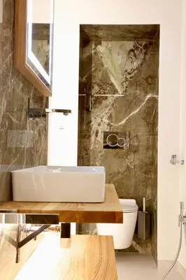a bathroom with a sink and a toilet at Domus Maxima - Rome Suite & Rooms in Rome
