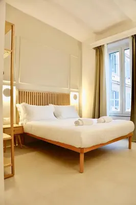 a bedroom with a bed and a window at Domus Maxima - Rome Suite & Rooms in Rome