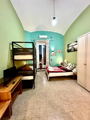 a room with two bunk beds and a desk at B&B Termini Colosseo Suite in Rome
