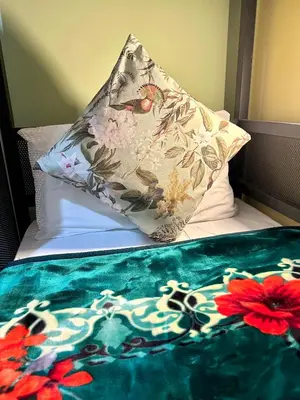 a bed with a pillow and a blanket on it at B&B Termini Colosseo Suite in Rome