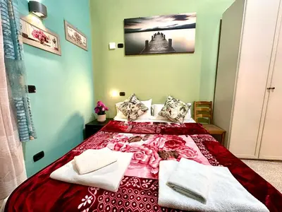 a bedroom with a bed with a red blanket at B&B Termini Colosseo Suite in Rome