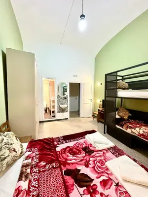 a bedroom with a large bed with a red spread at B&B Termini Colosseo Suite in Rome