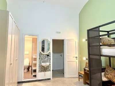 a bathroom with a toilet and a mirror in a room at B&B Termini Colosseo Suite in Rome
