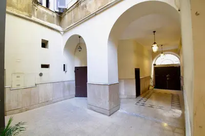 an empty hallway of a building with an archway at HC - In the heart of Campo de' Fiori in Rome