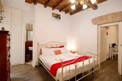 a bedroom with a bed with a red blanket at HC - In the heart of Campo de' Fiori in Rome