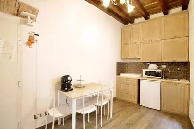 a kitchen with a table and chairs and a microwave at HC - In the heart of Campo de' Fiori in Rome