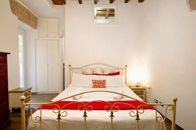 a bedroom with a bed with a red and white bedspread at HC - In the heart of Campo de' Fiori in Rome