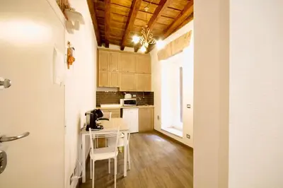 a kitchen with a table and chairs in a room at HC - In the heart of Campo de' Fiori in Rome