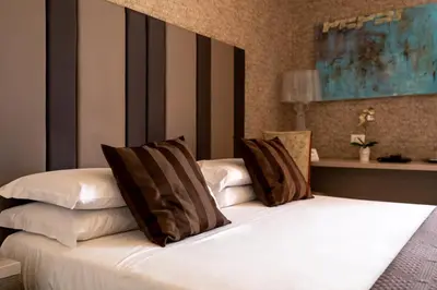 a bedroom with a bed with two pillows on it at Blue Inn Luxury Suites in Rome