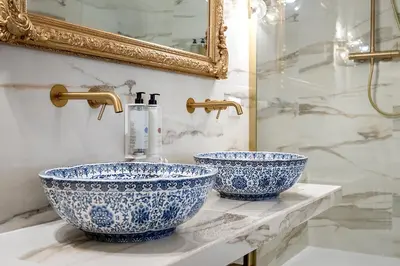 two blue and white sinks on a counter in a bathroom at Via Veneto 116 Suites - Guest House in Rome