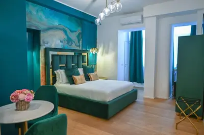 a bedroom with a bed and a table in a room at Via Veneto 116 Suites - Guest House in Rome