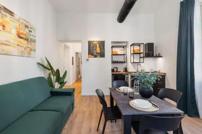 a living room with a green couch and a table at Adelante Apartment in Rome