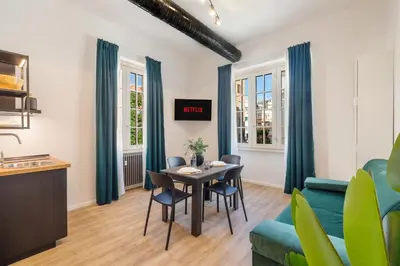 a living room with a table and a blue couch at Adelante Apartment in Rome