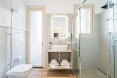 a bathroom with a toilet sink and a shower at Adelante Apartment in Rome
