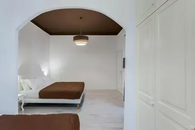 a bedroom with a bed in a white room at Gilda Apartment New elegant apartment in Termini in Rome