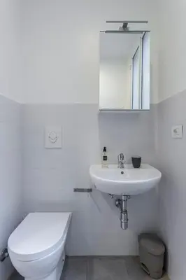 a white bathroom with a toilet and a sink at Gilda Apartment New elegant apartment in Termini in Rome