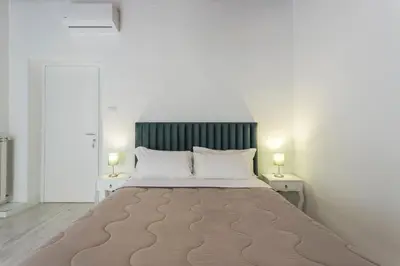 a bedroom with a large bed with two lamps at Gilda Apartment New elegant apartment in Termini in Rome