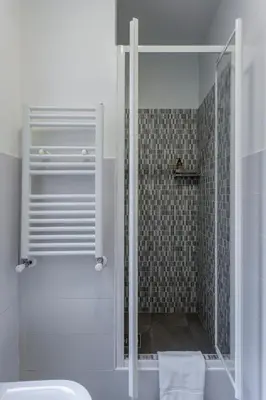 a shower with a glass door in a bathroom at Gilda Apartment New elegant apartment in Termini in Rome