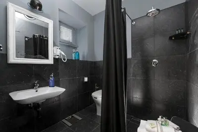 a bathroom with a shower and a sink and a toilet at Daniele Manin Roma in Rome