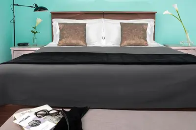 a bedroom with a large bed with glasses on it at Daniele Manin Roma in Rome
