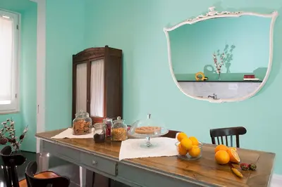 a table with a mirror and some fruit on it at Daniele Manin Roma in Rome