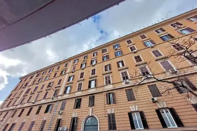 a large building with many windows on the side of it at Misa Guest House San Lorenzo in Rome
