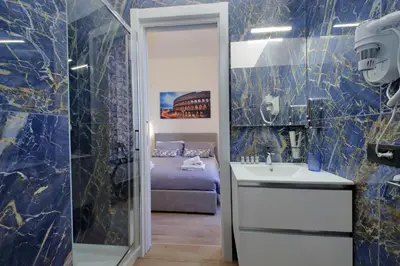 a bathroom with a sink and a bed in a room at Misa Guest House San Lorenzo in Rome